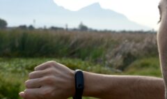 An adult exerciser reviewing a fitness tracker before a training session