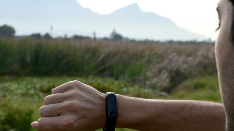 An adult exerciser reviewing a fitness tracker before a training session