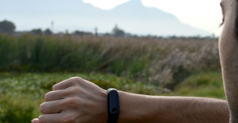 An adult exerciser reviewing a fitness tracker before a training session