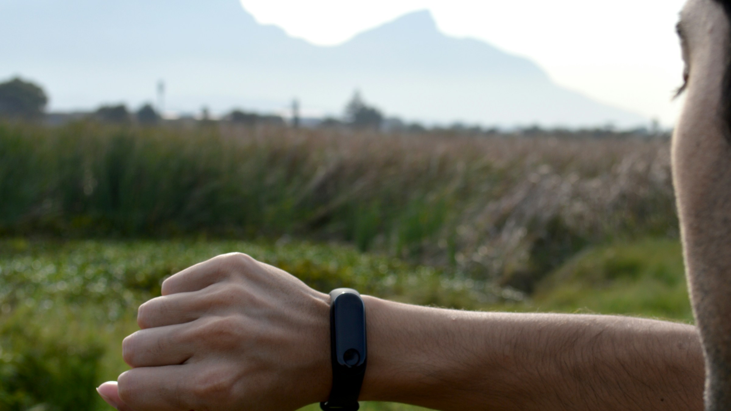 An adult exerciser reviewing a fitness tracker before a training session