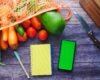 Fresh vegetables beside a notebook and phone used for planning a structured diet break