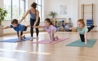 Children practising kneeling arm-and-leg extensions on colourful Pilates mats with an instructor.
