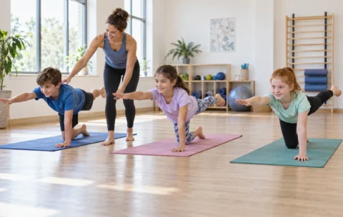 Children practising Pilates movements with an instructor