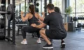 Personal trainer coaching a client through a strength exercise