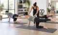 Instructor demonstrating mat Pilates exercises on a studio floor
