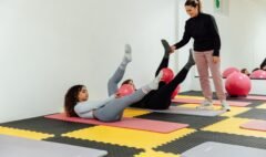 Adults exercising on mats in a bright studio