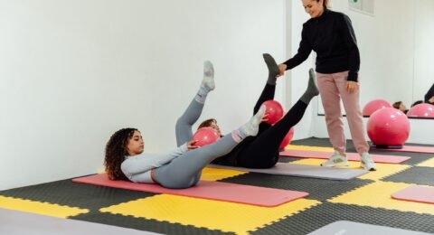 Adults exercising on mats in a bright studio