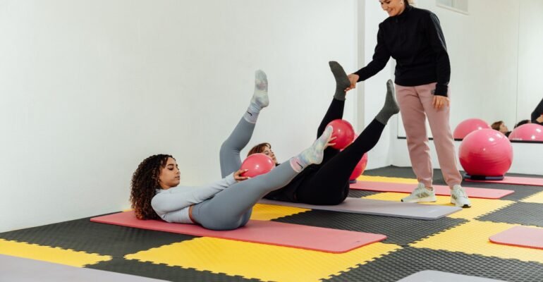 Adults exercising on mats in a bright studio