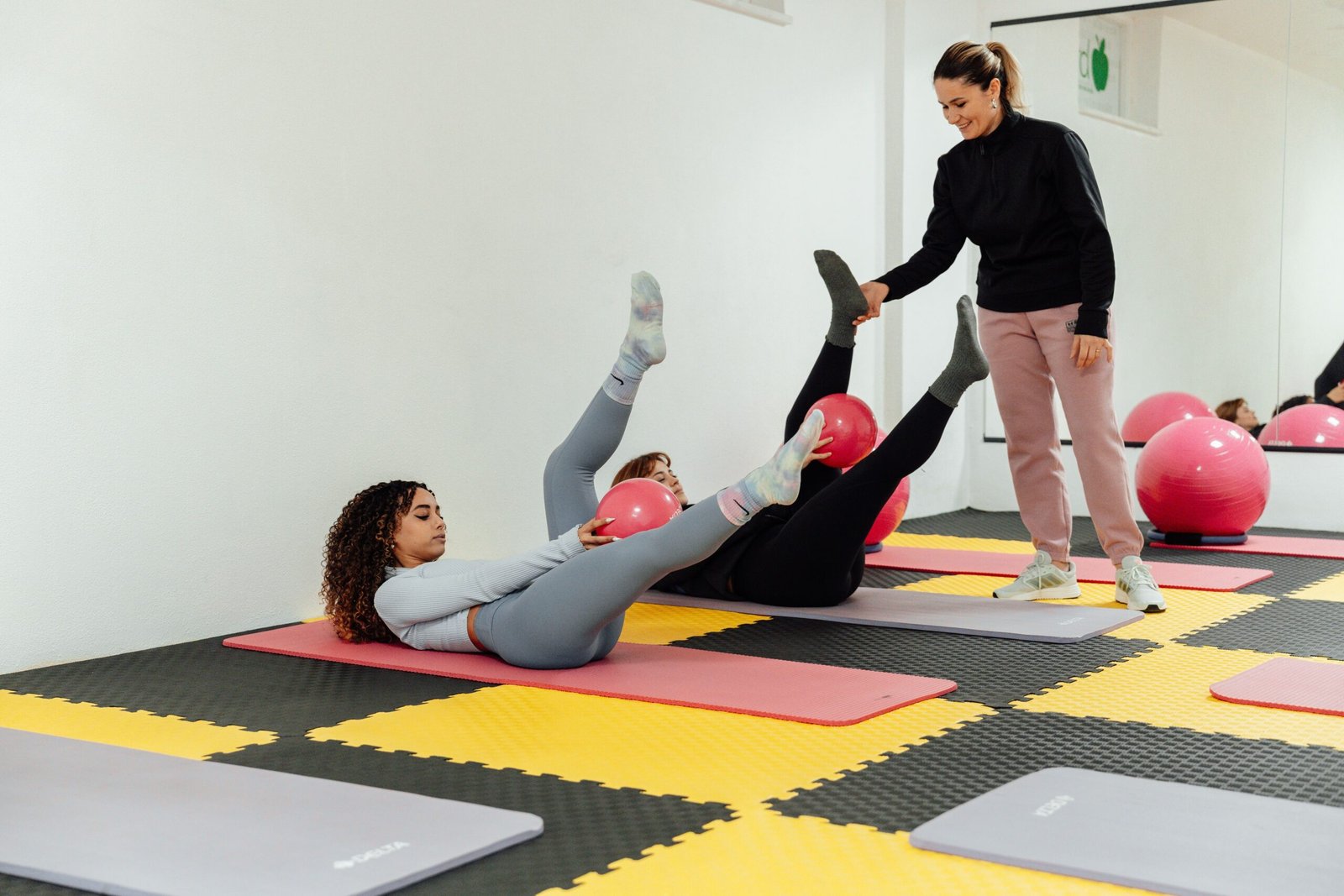 Adults exercising on mats in a bright studio