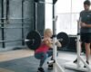 Personal trainer coaching an adult through a controlled front squat