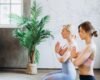 Yoga instructor guiding an adult through gentle slow breathing in a calm studio