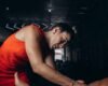 Sports massage practitioner working on an adult athlete’s leg after training